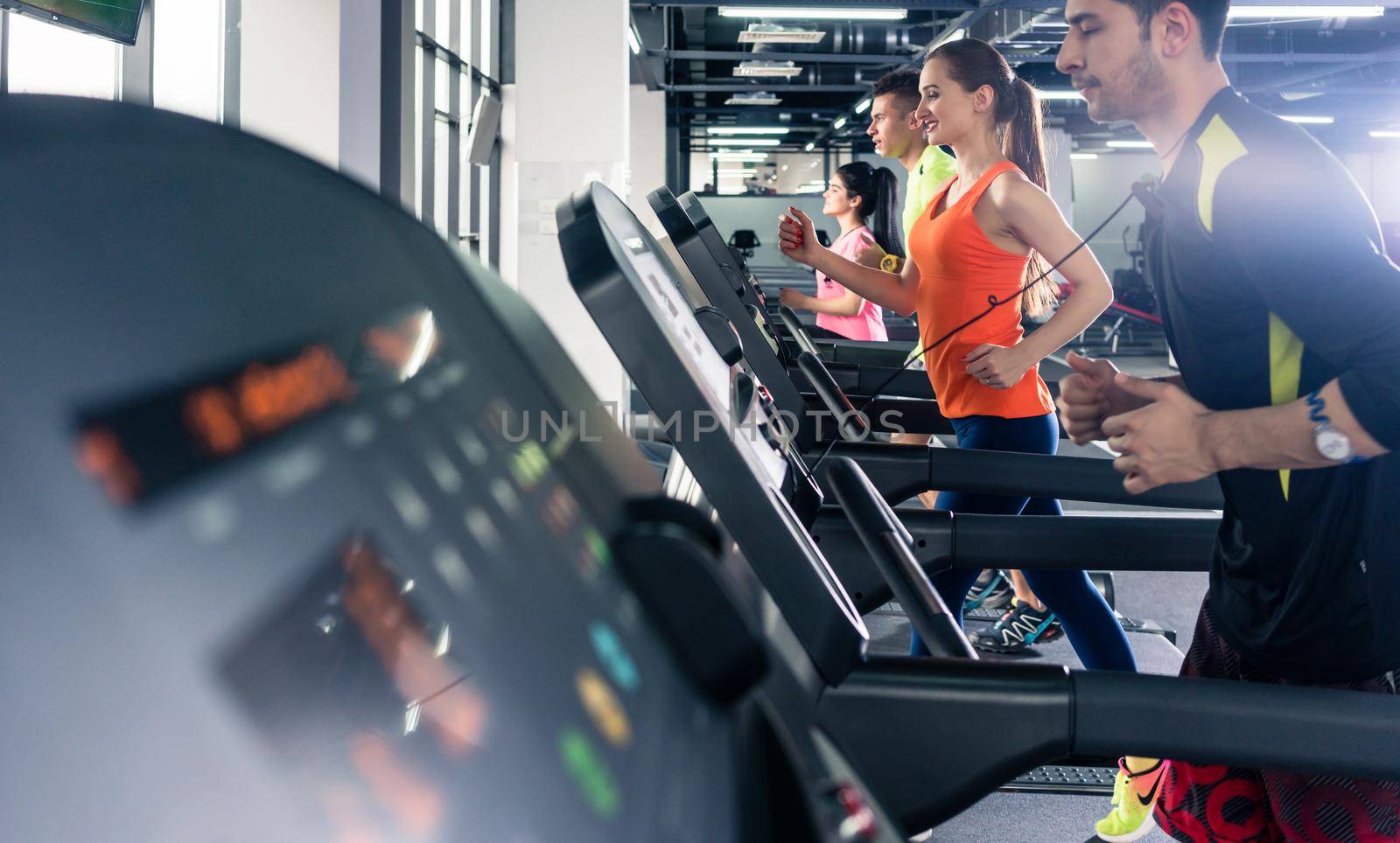 People exercising on treadmill by Kzenon