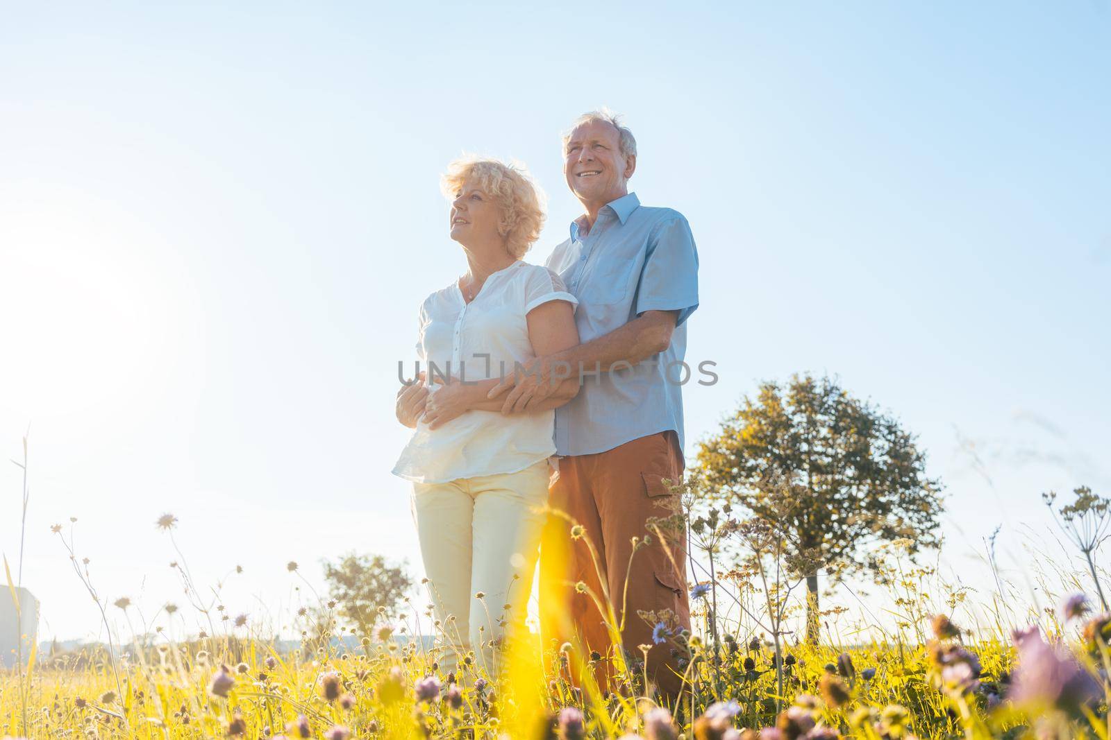 Romantic elderly couple enjoying health and nature in a sunny day of summer by Kzenon