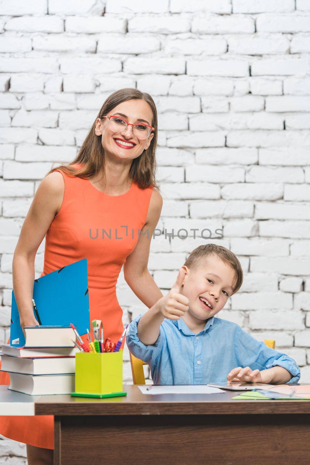 Teacher woman and school student looking at the camera