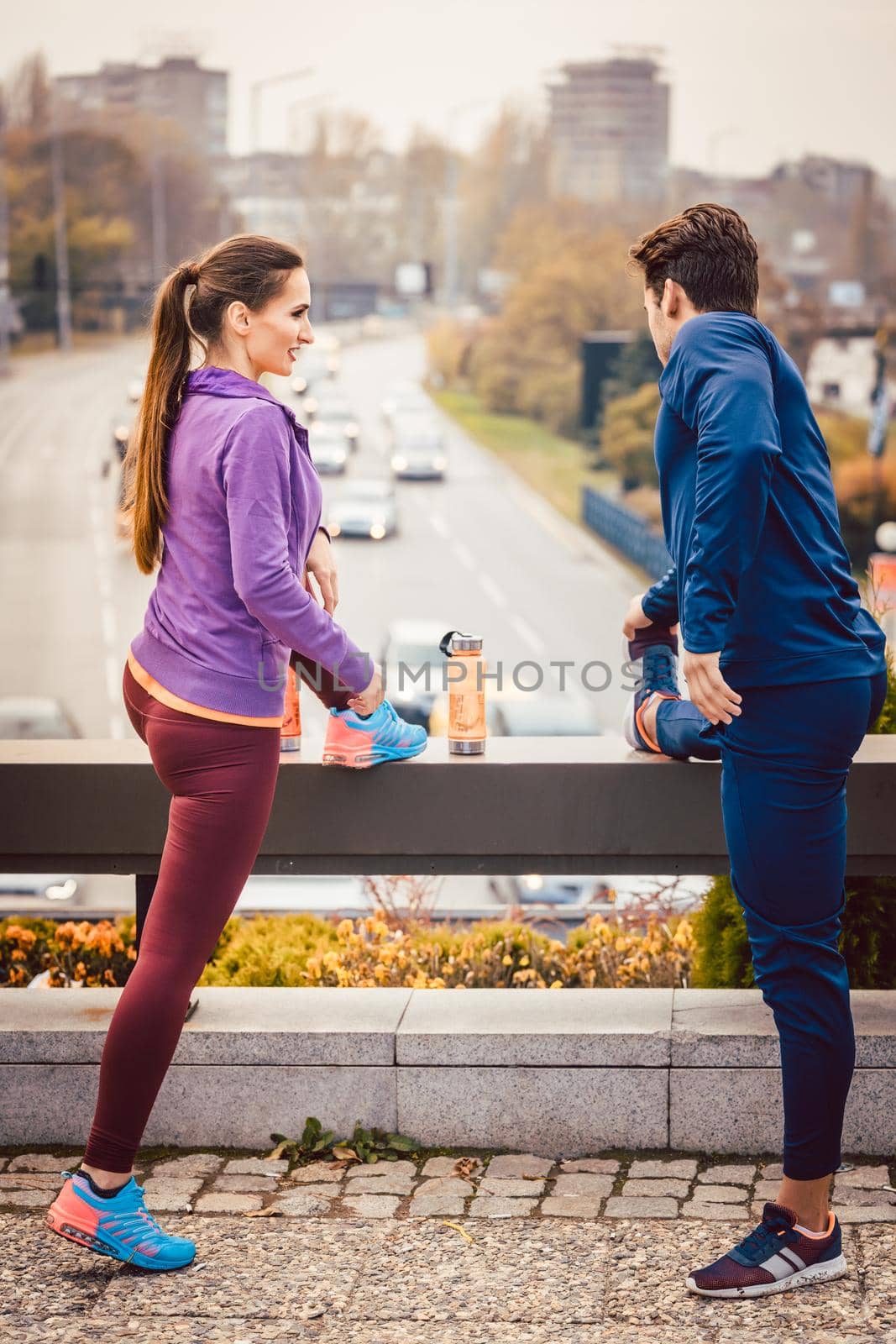 Athletic couple exercising for better fitness in a modern city