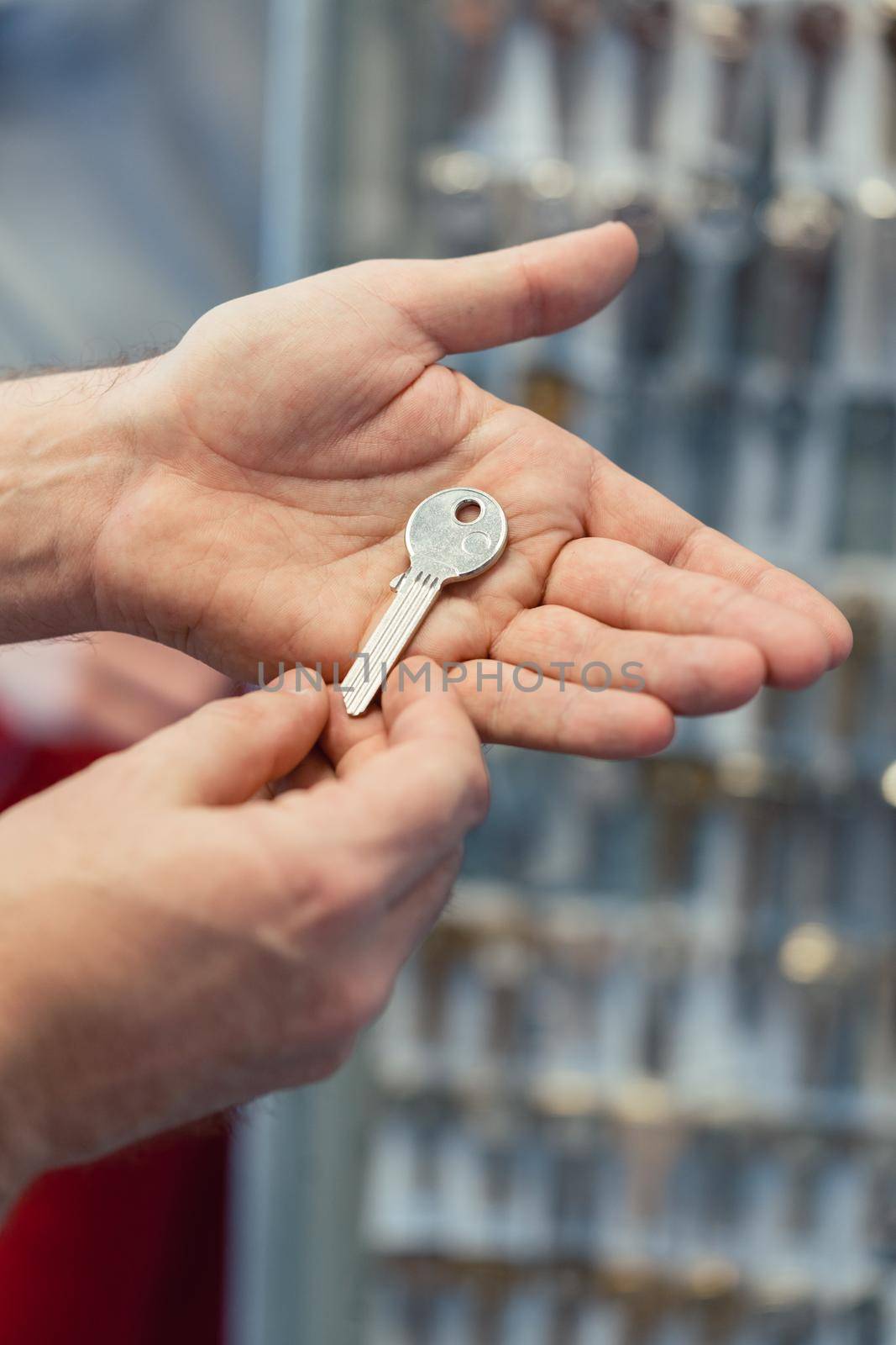 Locksmith showing key blanks in his shop