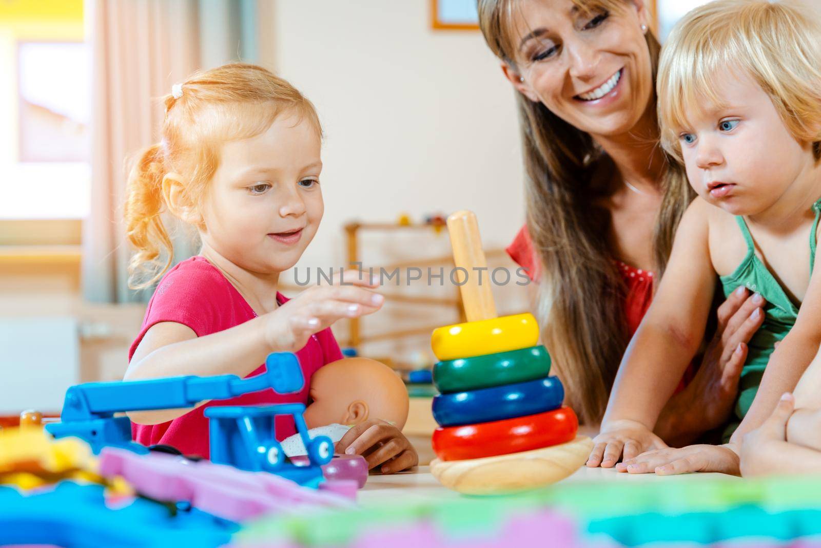 Children in nursery school learning and playing by Kzenon