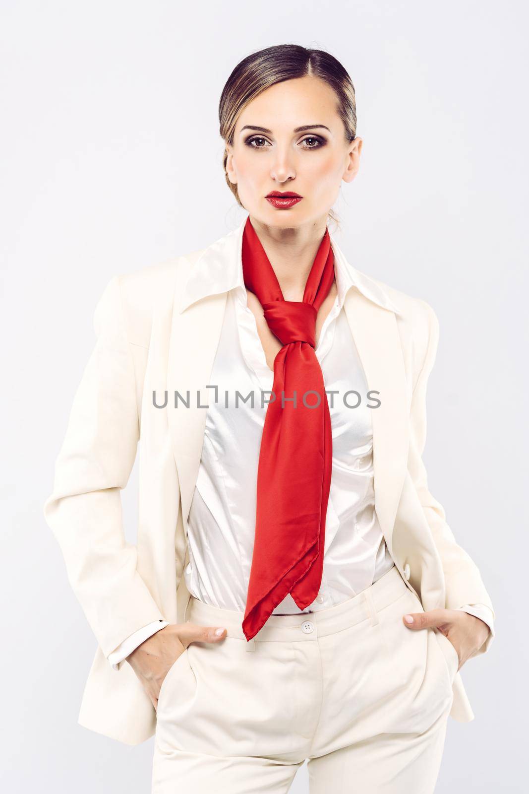 Elegant and expensive model wearing white business suit in studio shot