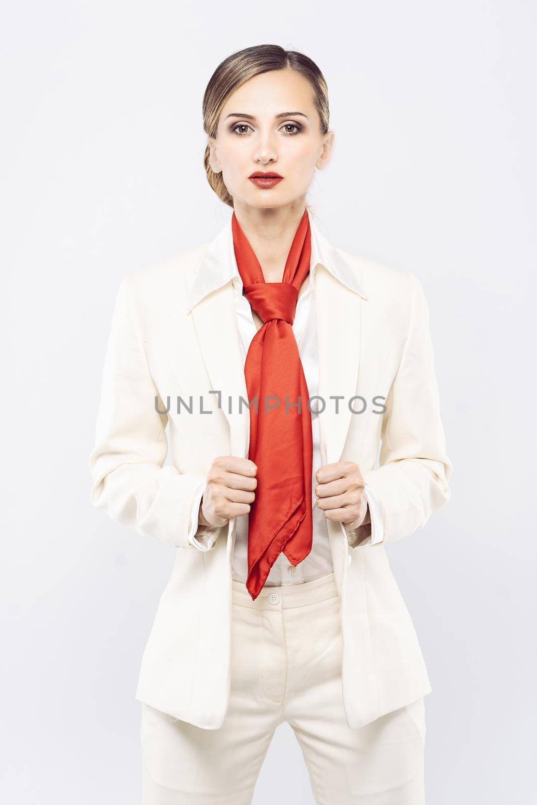 Elegant and expensive model wearing white business suit in studio shot