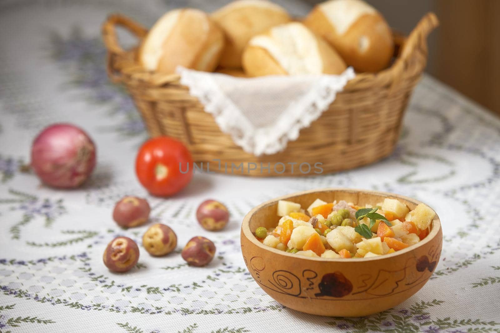 Traditional peruvian meal Matasquita with raw vegetable and basket of bread