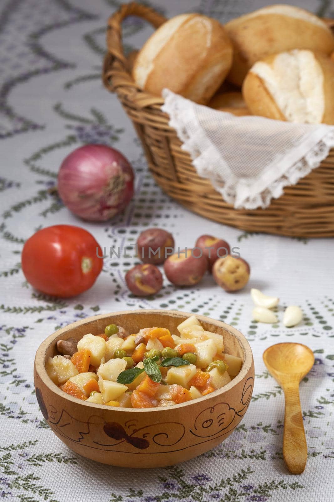 Traditional peruvian meal Matasquita with raw vegetable and basket of bread