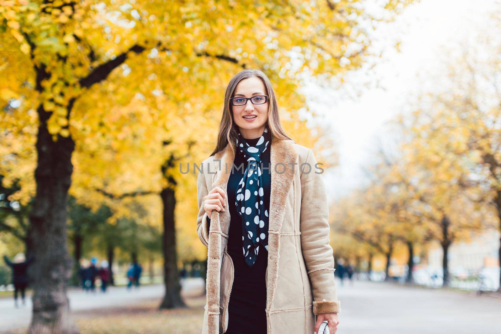 Beautiful woman in autumn with colorful trees in the background