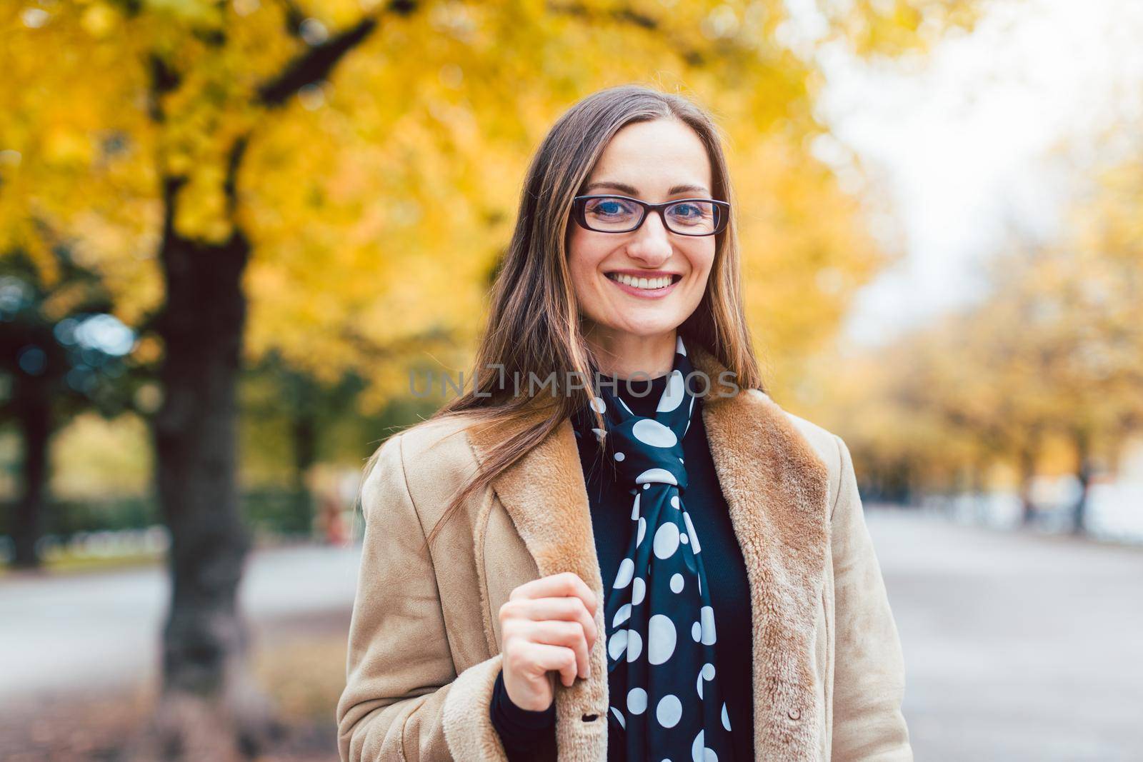 Beautiful woman in autumn with colorful trees in the background