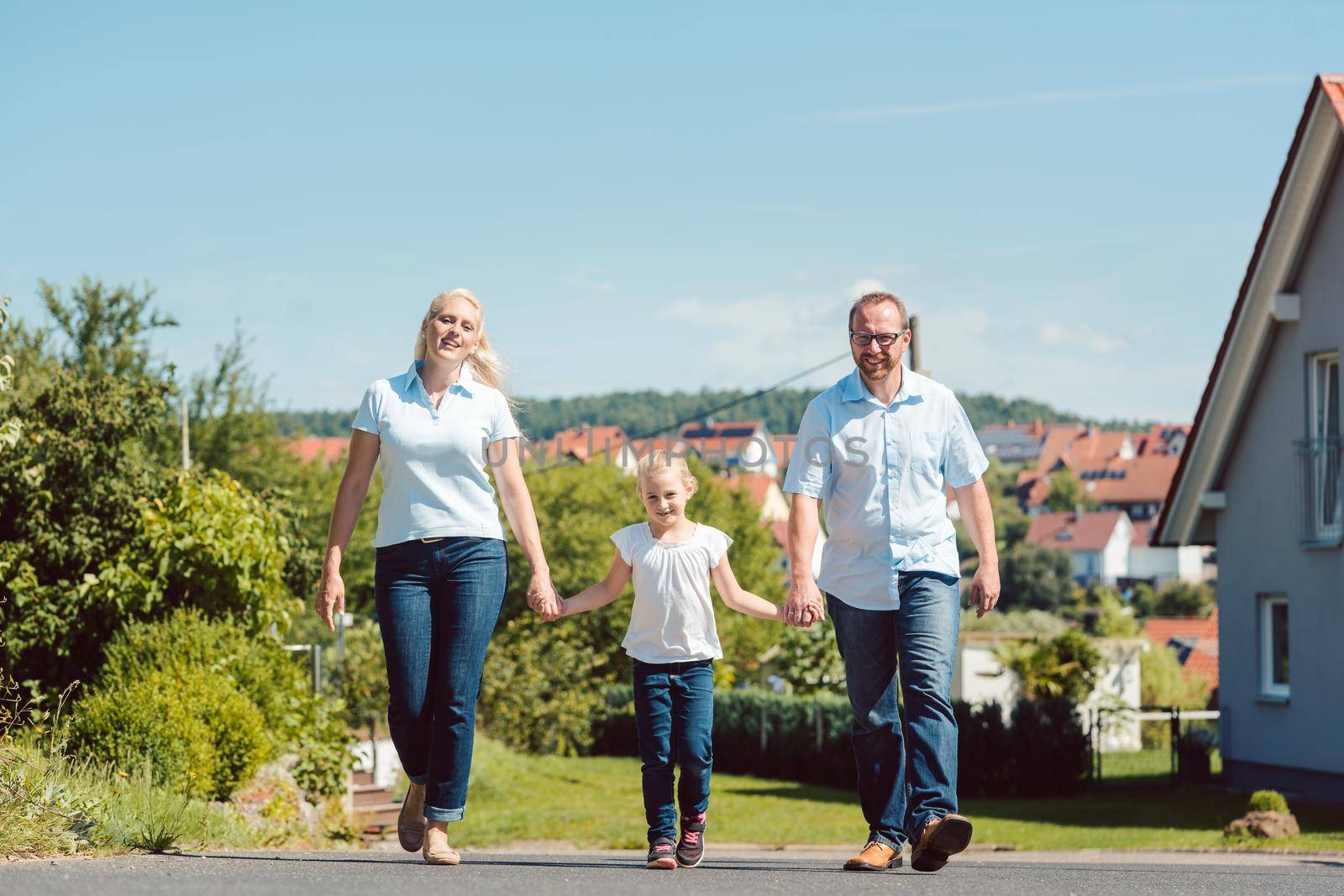 Family having walk in the village on summer day