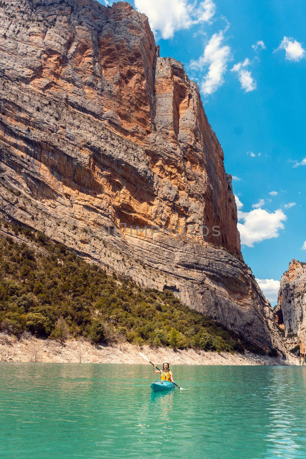 Woman on a kayak in the Pyrenees mountains in Catalonia by Kzenon