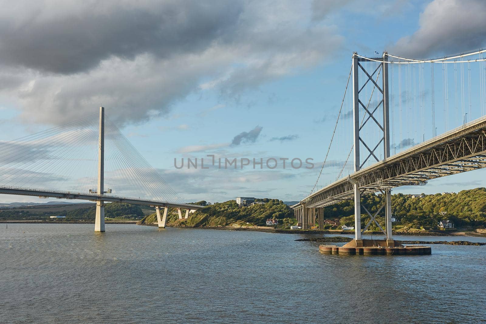 The new Queensferry Crossing bridge over the Firth of Forth with the older Forth Road bridge in Edinburgh Scotland. by wondry
