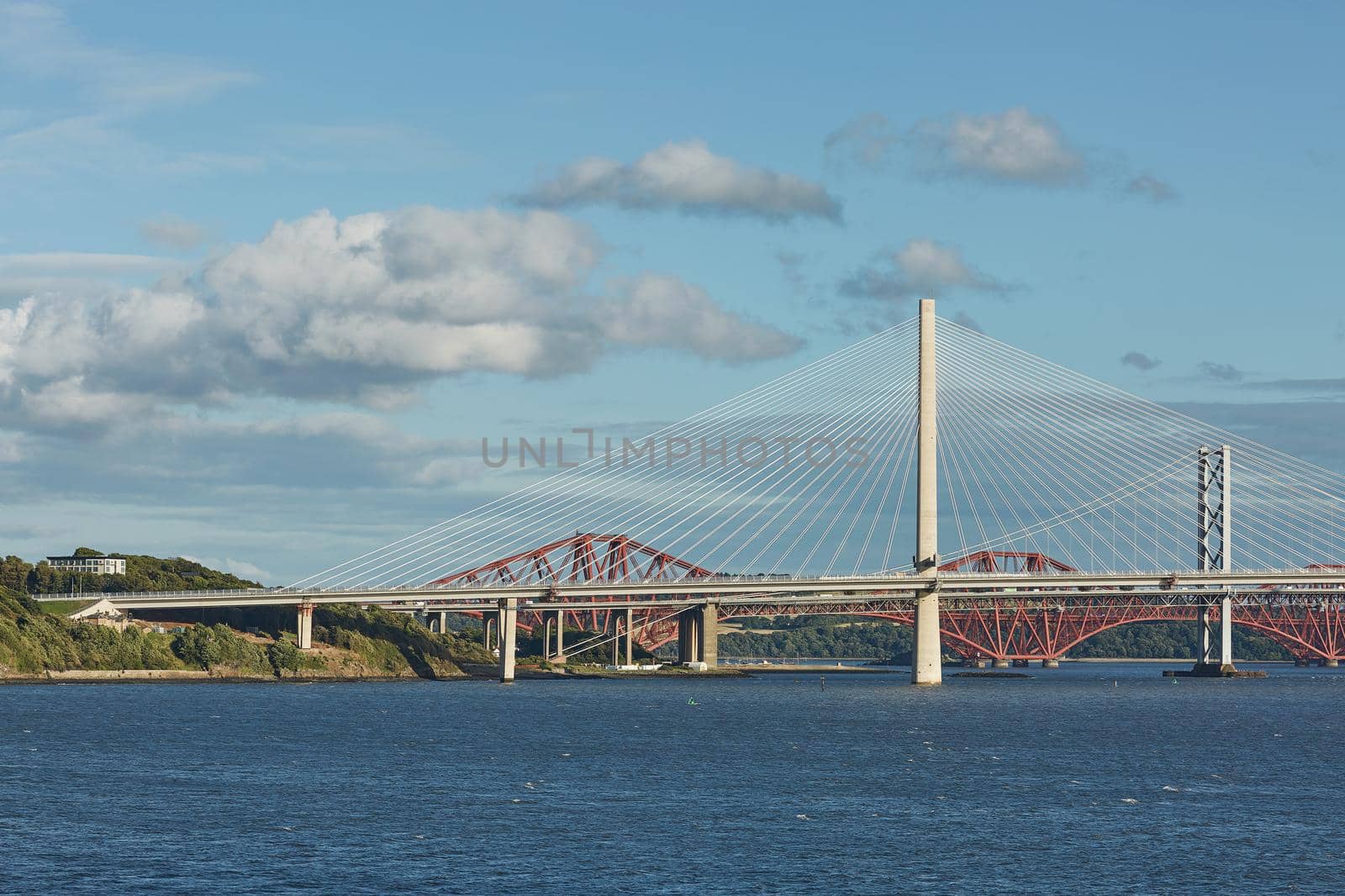 The new Queensferry Crossing bridge over the Firth of Forth with the older Forth Road bridge and the iconic Forth Rail Bridge in Edinburgh Scotland. by wondry
