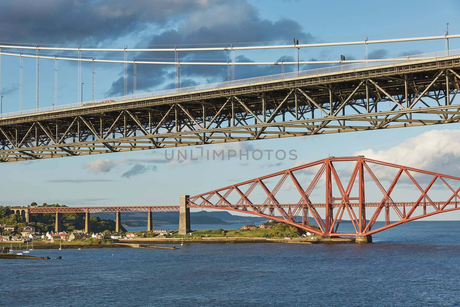 Older Forth Road bridge and the iconic Forth Rail Bridge in Edinburgh Scotland. by wondry