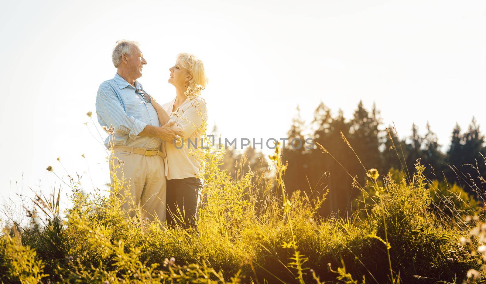 Senior woman and man hugging still being in love in a romantic setting