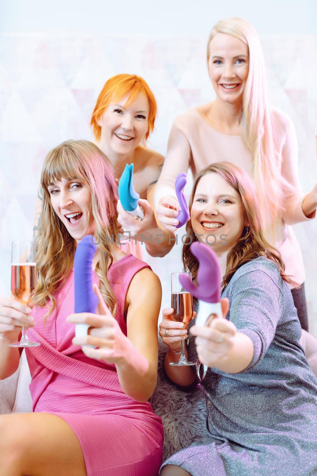 Women showing sex toys they bought at a dildo party and drinking champagne