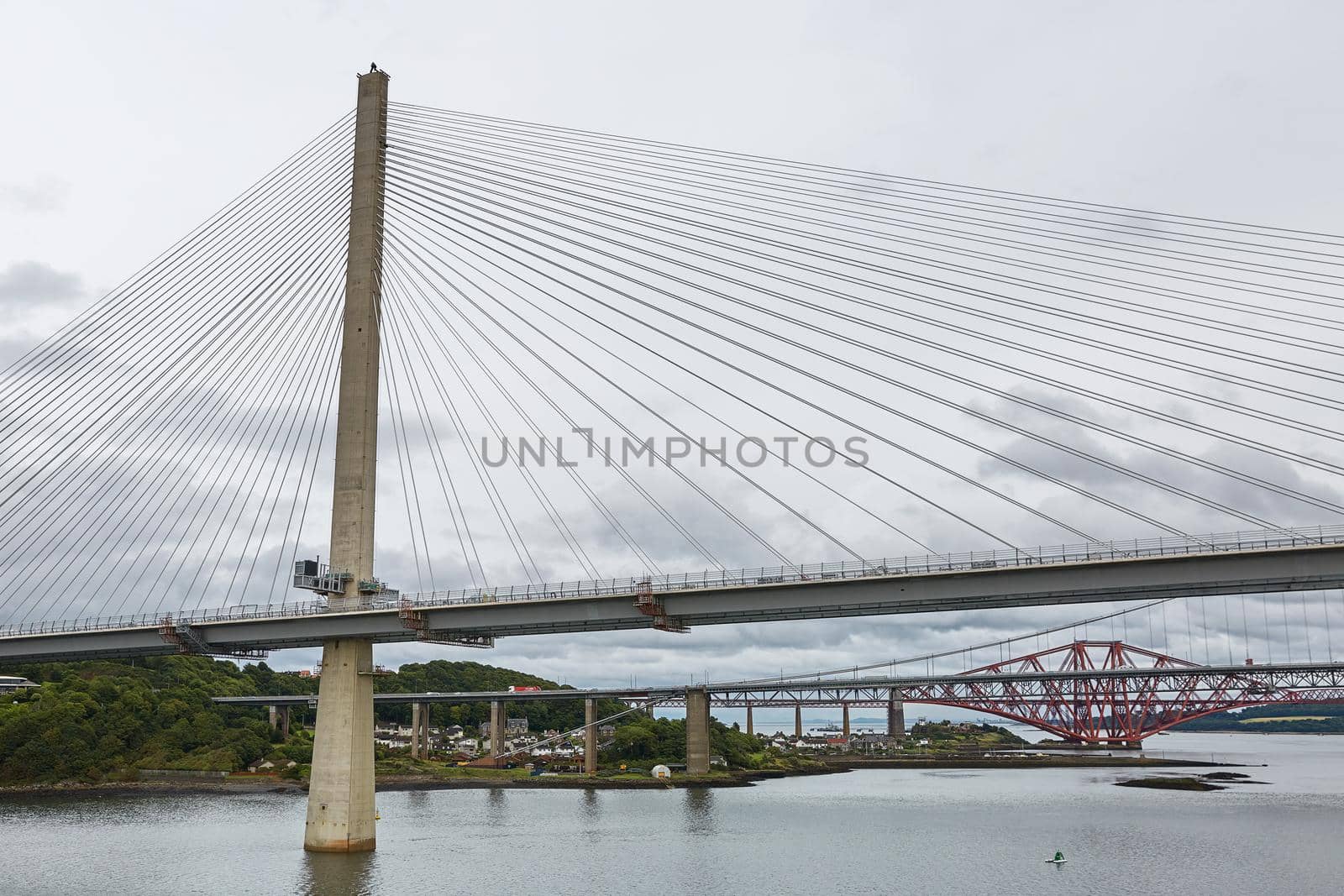 The new Queensferry Crossing bridge over the Firth of Forth with the older Forth Road bridge and the iconic Forth Rail Bridge in Edinburgh Scotland