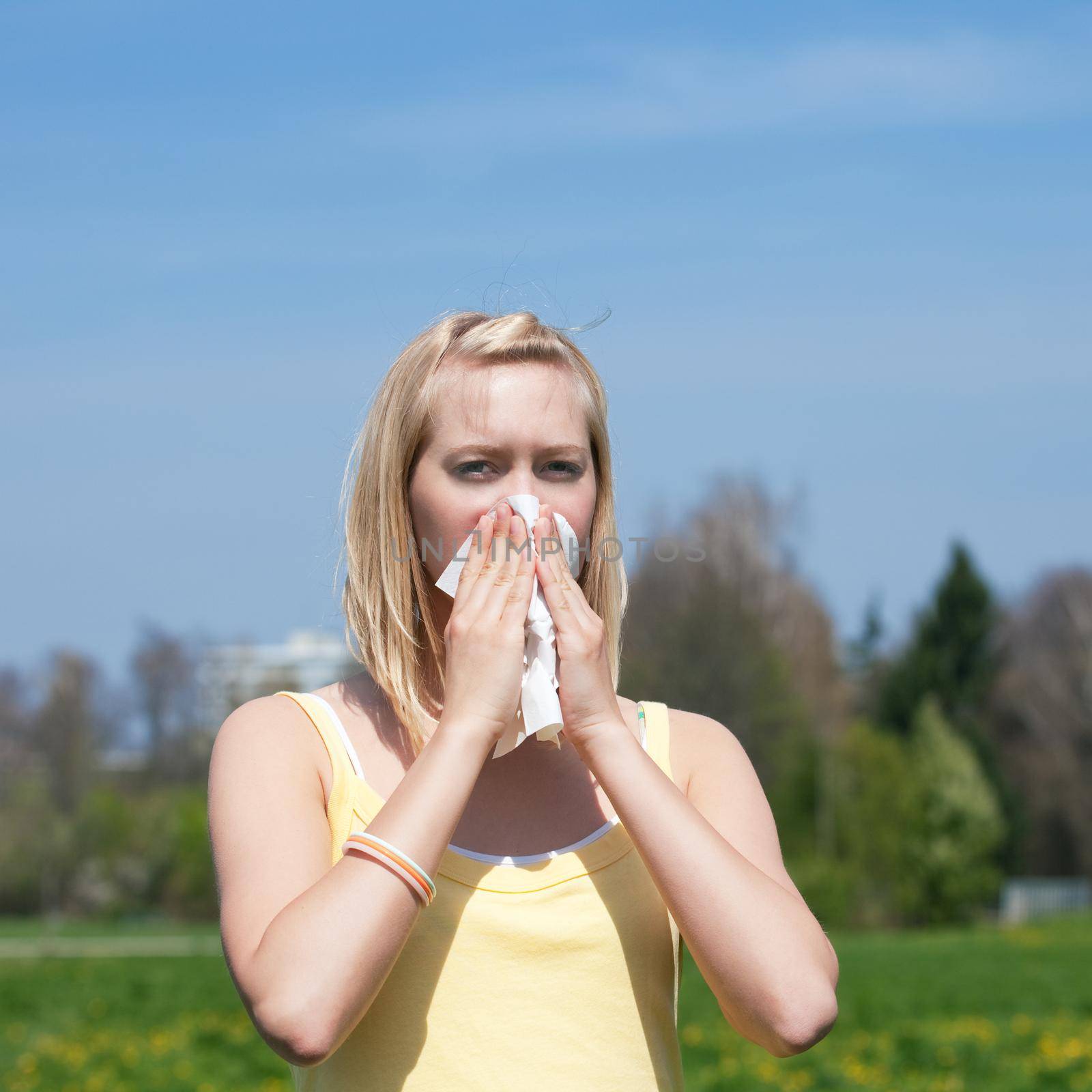 Woman with allergy sneezing by Kzenon