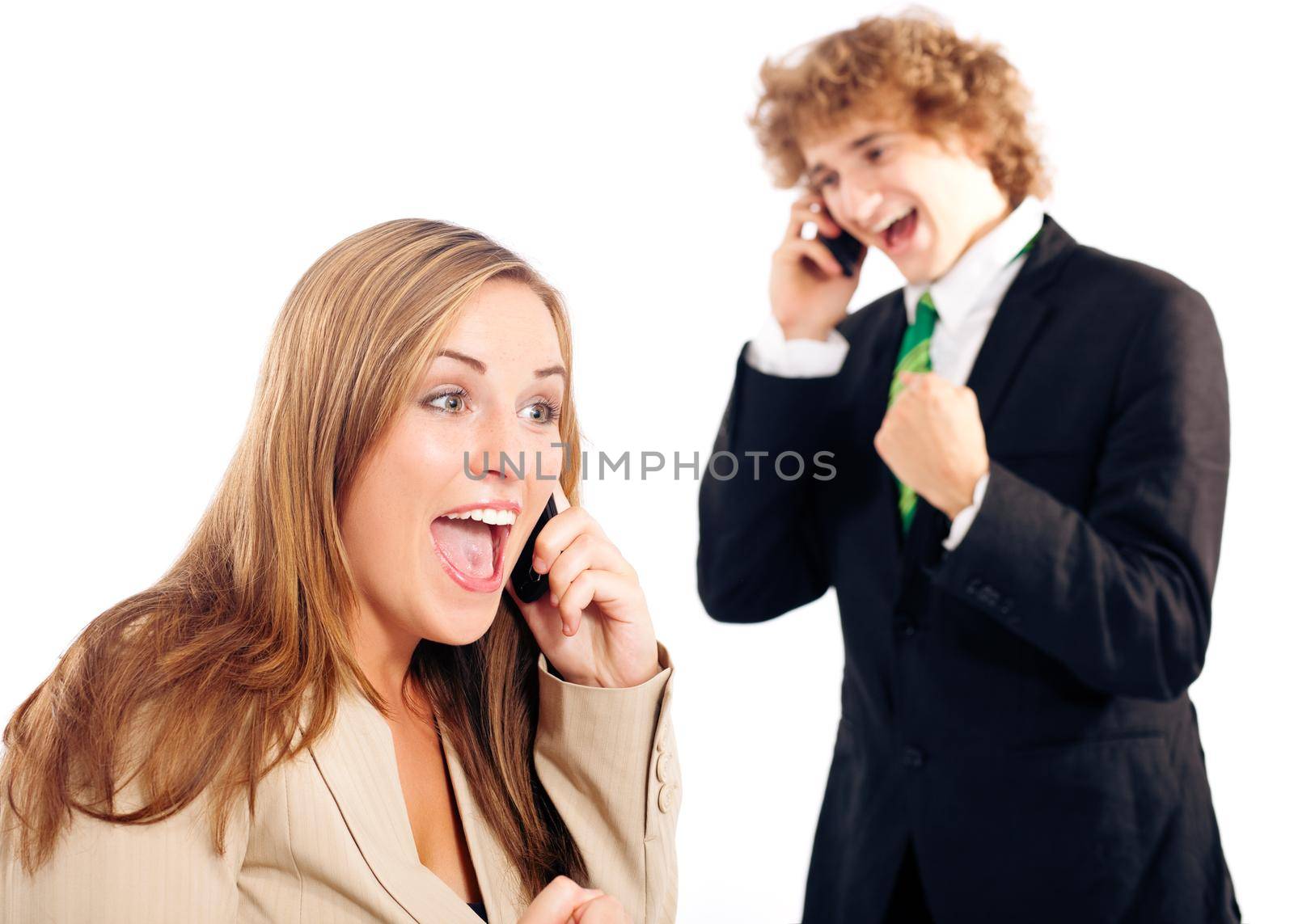 Business people - both are on their mobile phone, both are very happy