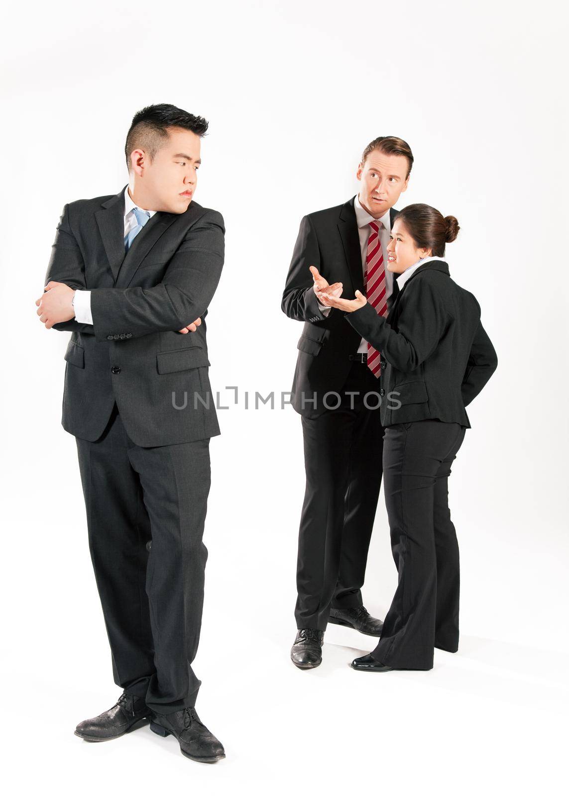 Business people (multi-ethnic) pointing their fingers on a colleague - mobbing