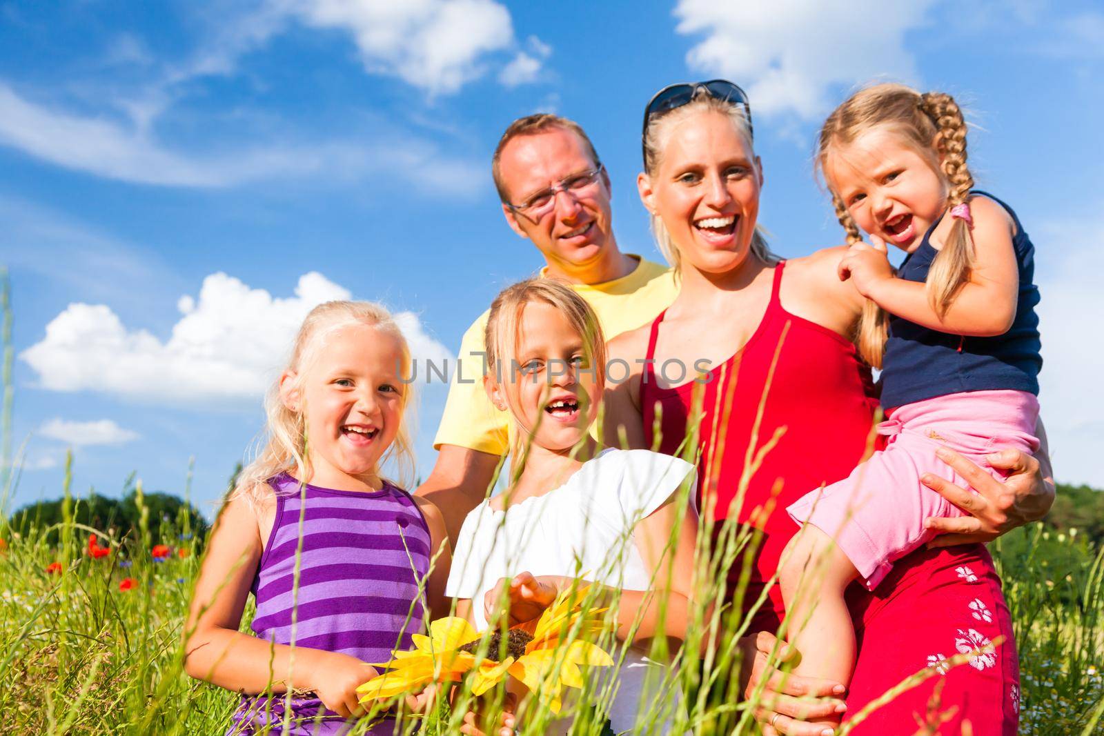 Family in grass in summer by Kzenon