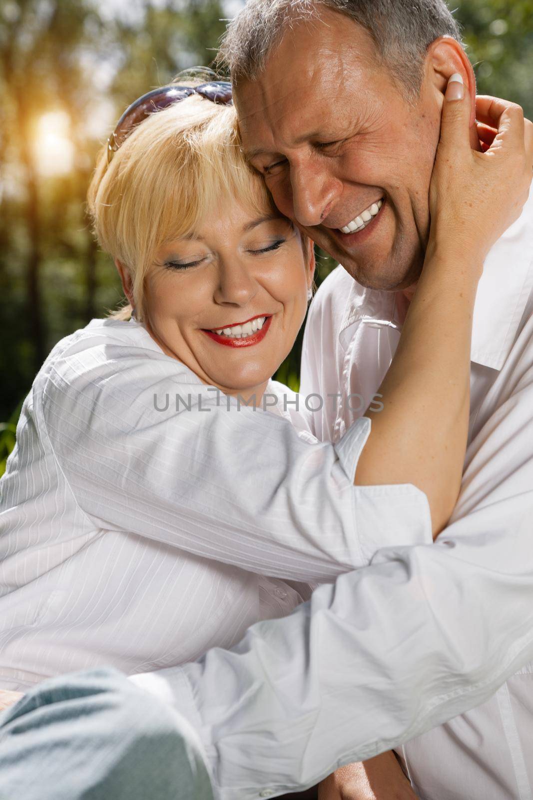 Senior couple sitting on beautiful spring day in love