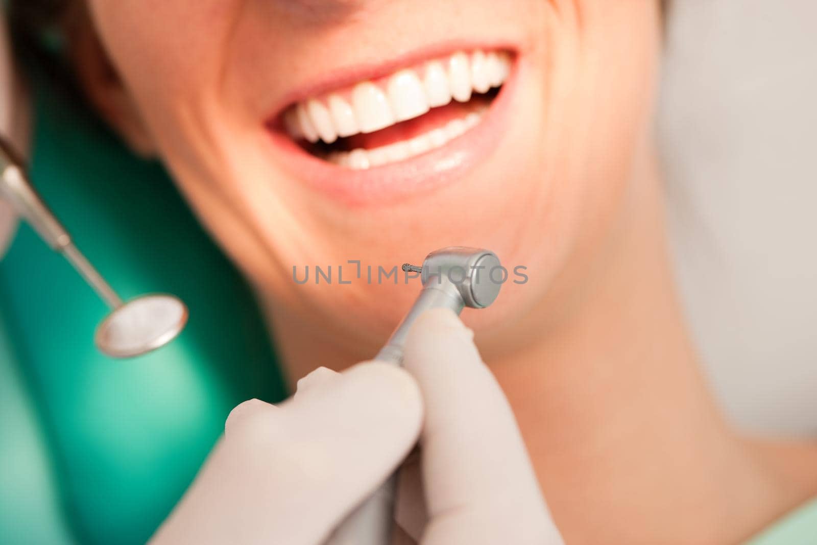 Female patient with dentist in the course of a dental treatment, FOCUS ON DRILL