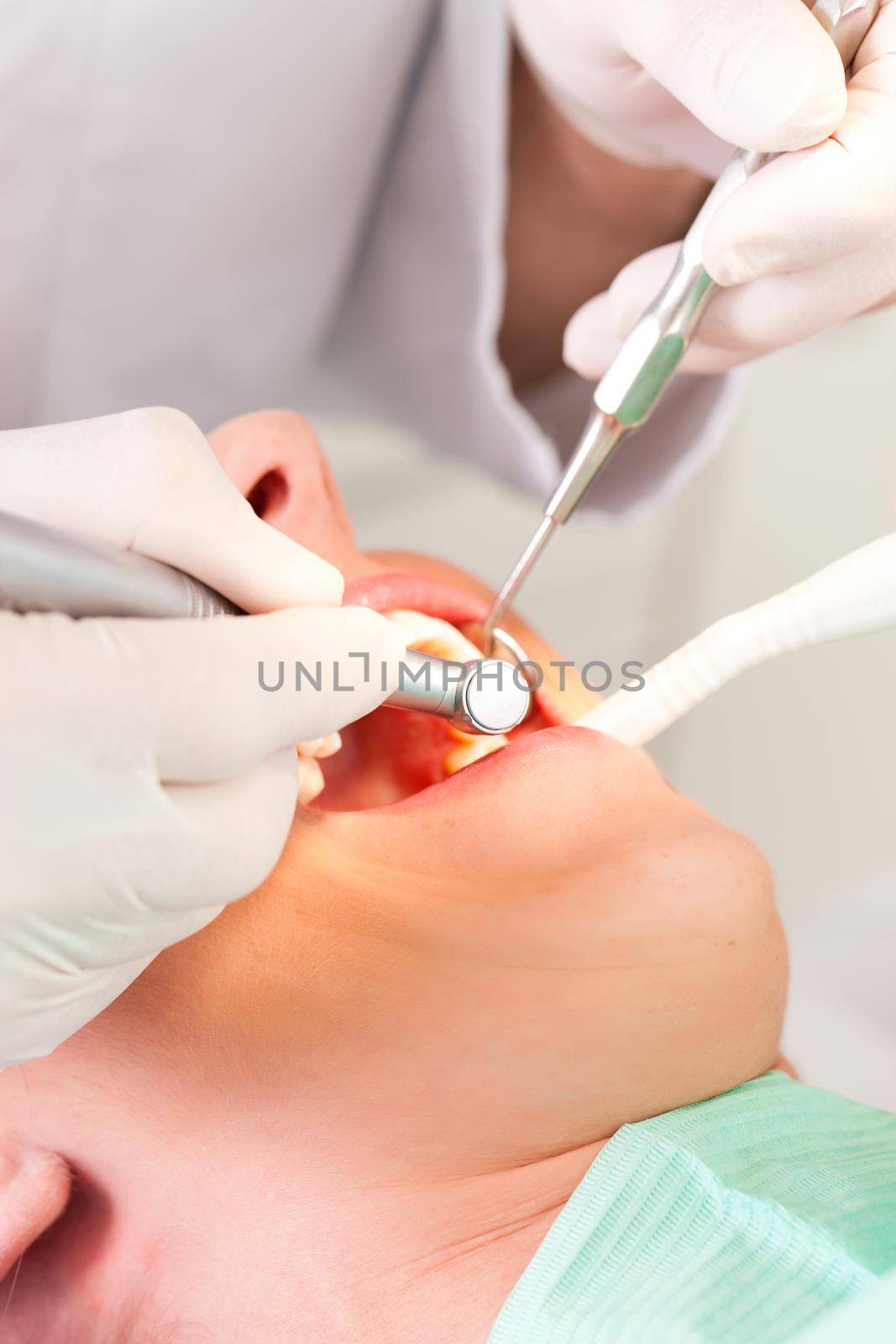 Female patient with dentist in the course of a dental treatment