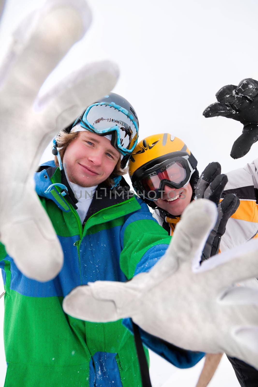 Skier and snowboarder in the snow posing for the camera