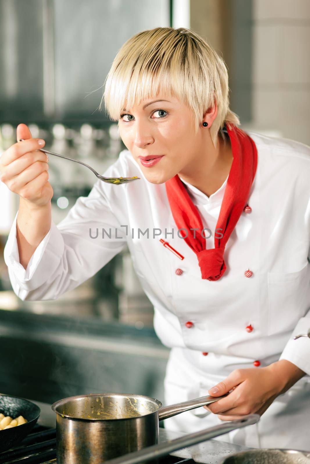 Female Chef in a restaurant kitchen tasting by Kzenon