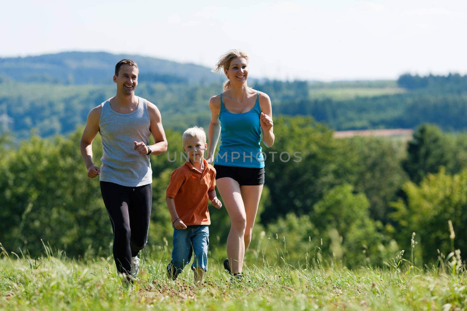 Active Family jogging outdoors in beautiful summer landscape 