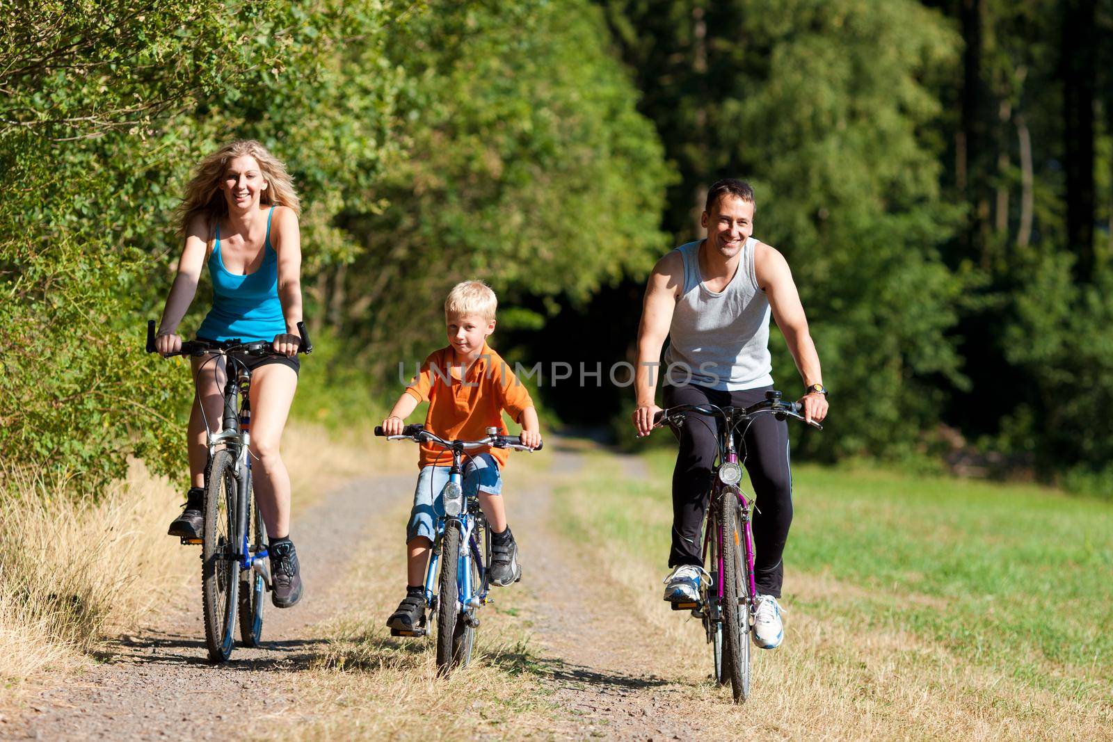 Family riding bicycles for sport by Kzenon