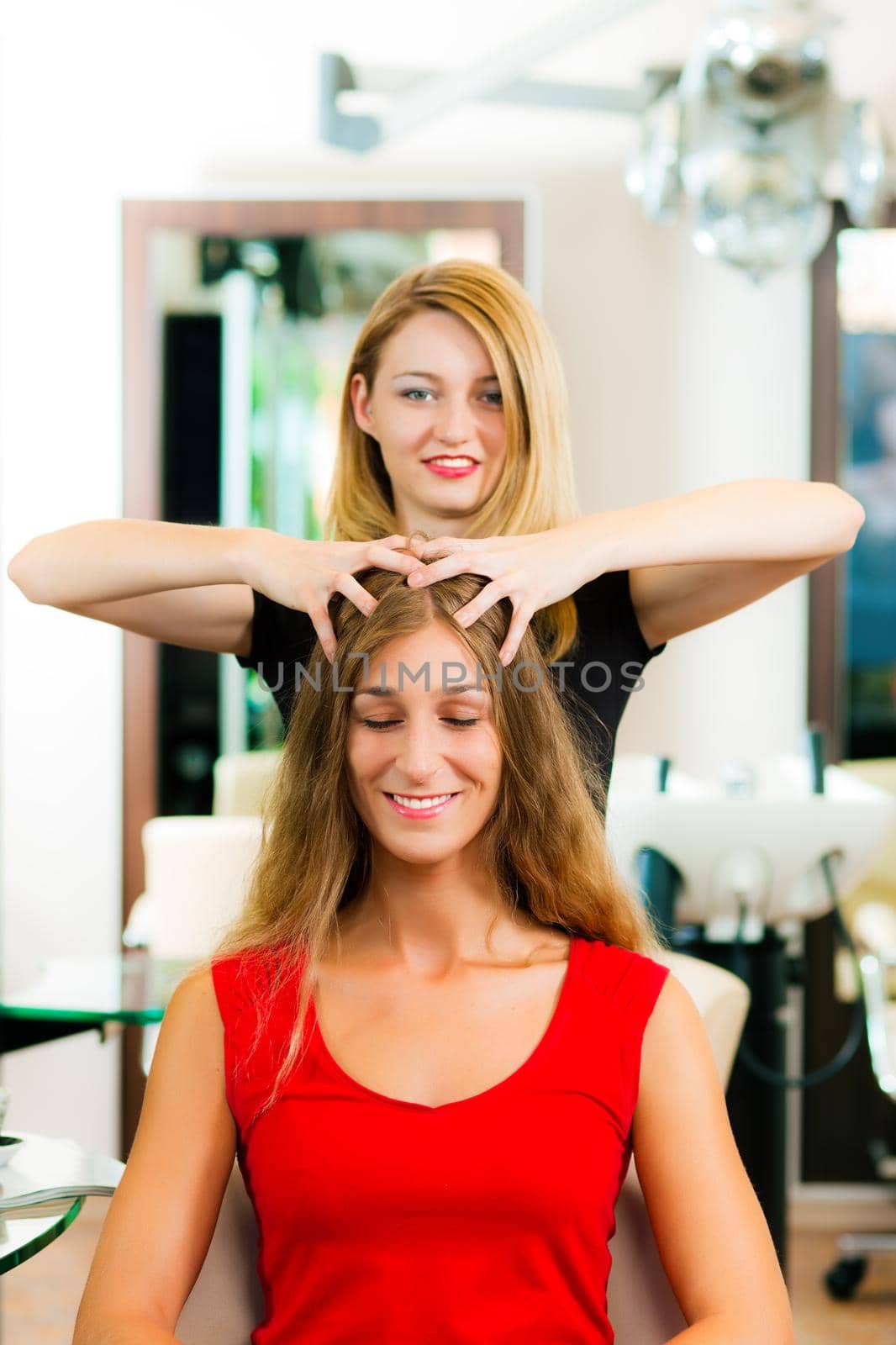 Woman at the hairdresser getting a head massage in the salon