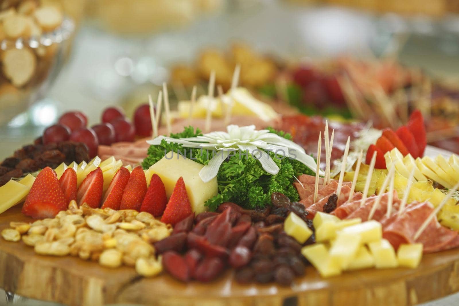Catering service with various fruits and vegetables on wooden plate