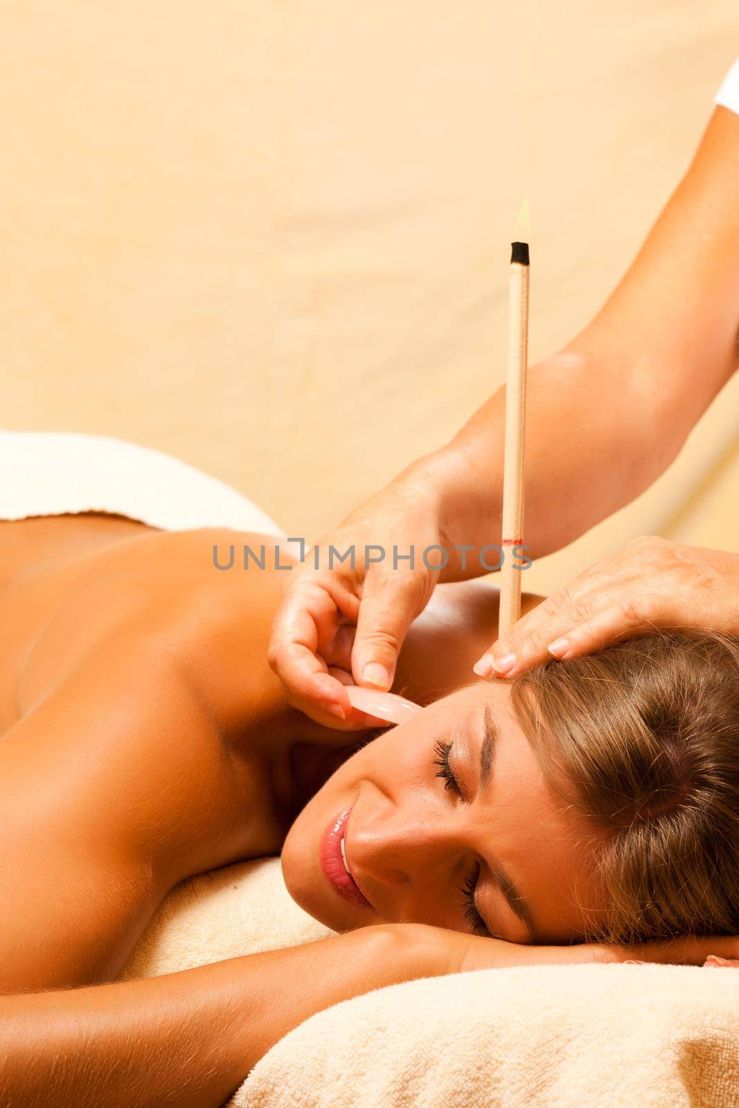 Woman in therapy with ear candles by Kzenon