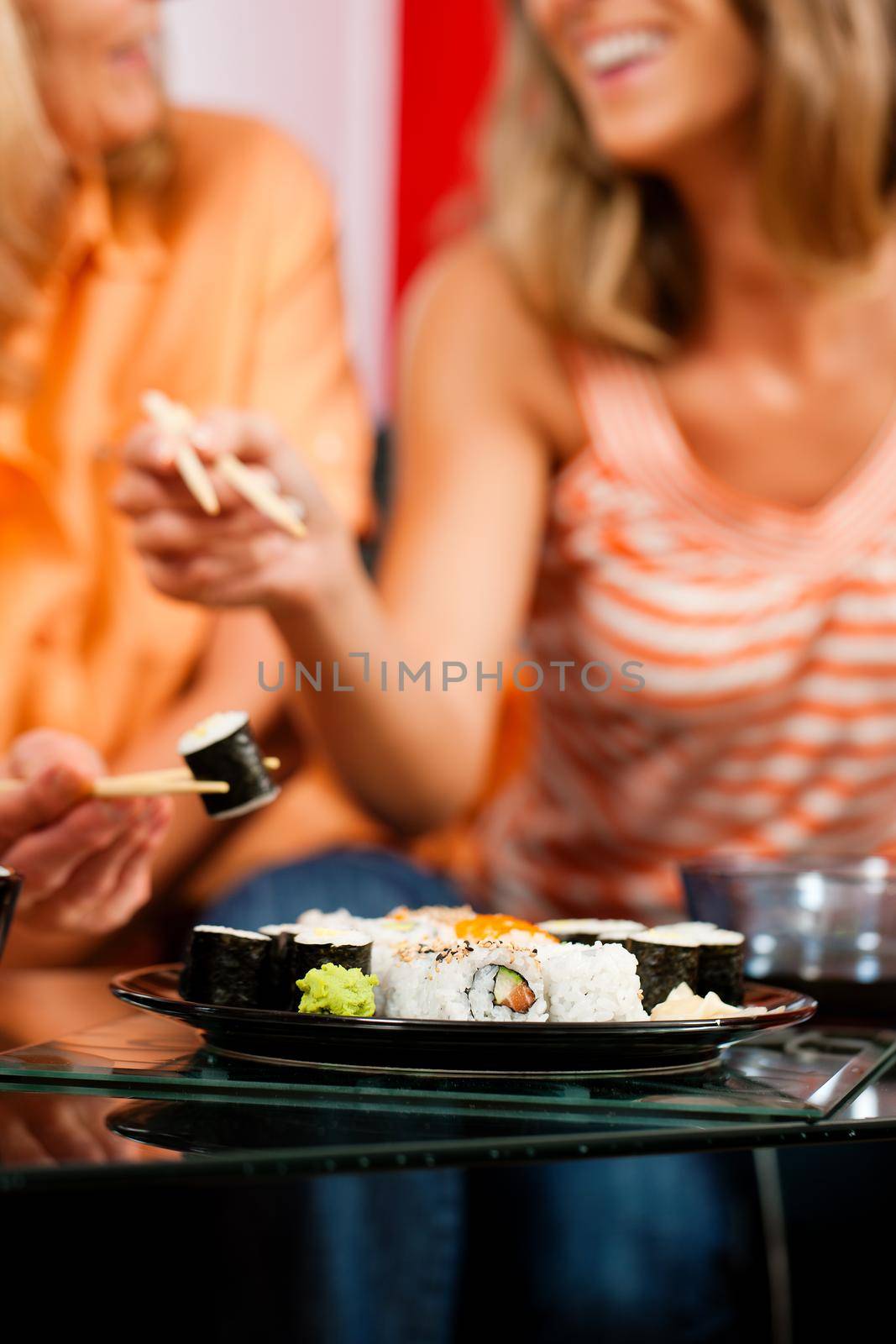 Two women eating sushi by Kzenon