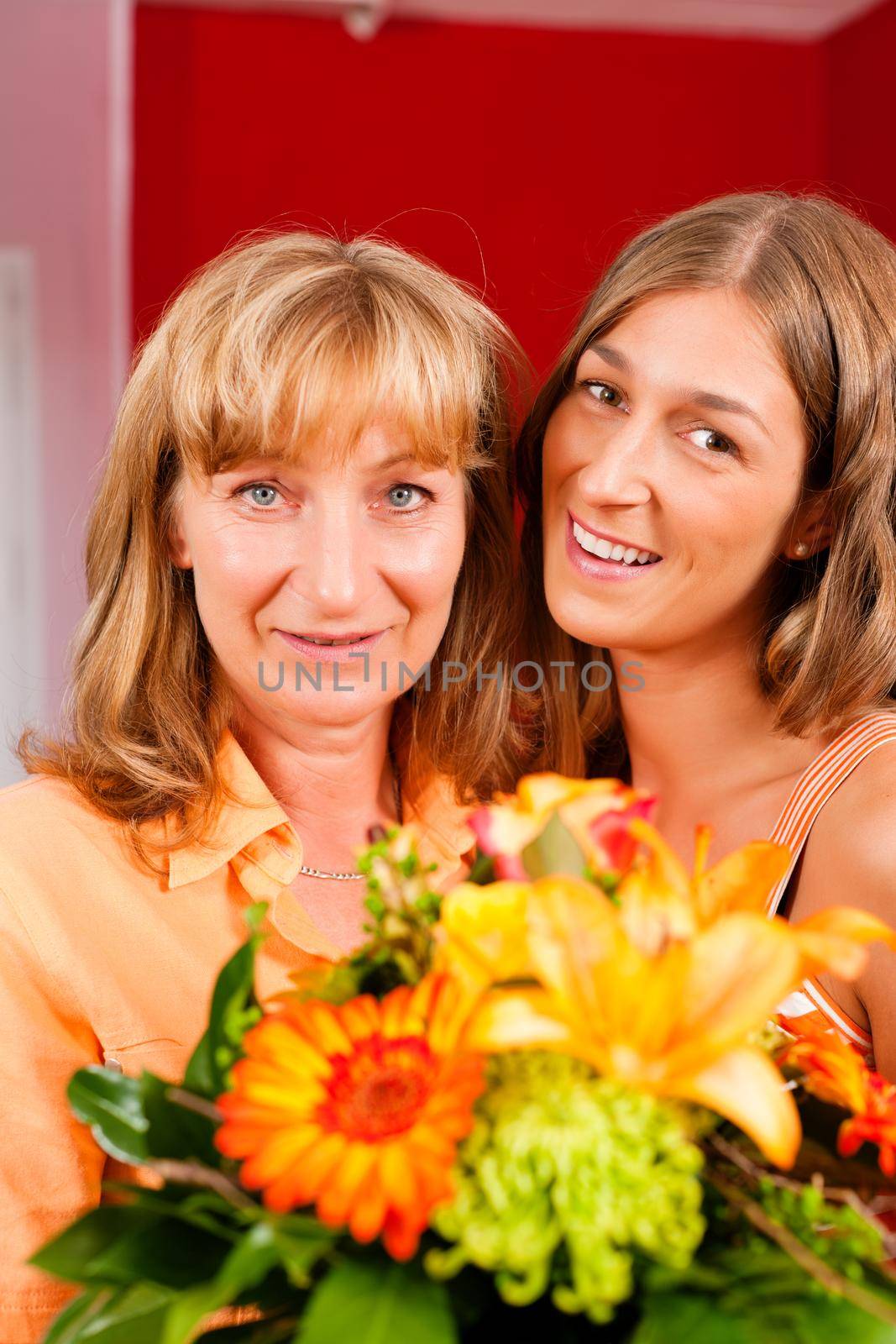 Mother and daughter - the daughter has given her mother flowers