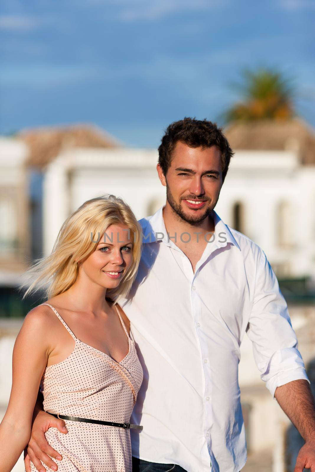 Couple having a city break in summer walking in the evening light