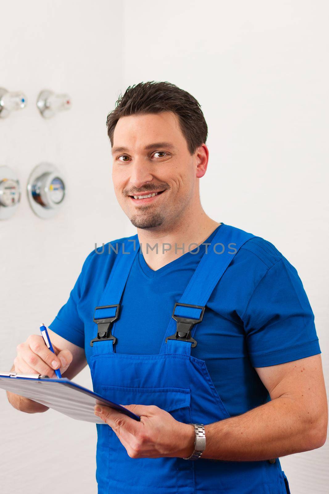 Technician reading the water meter to check consumption