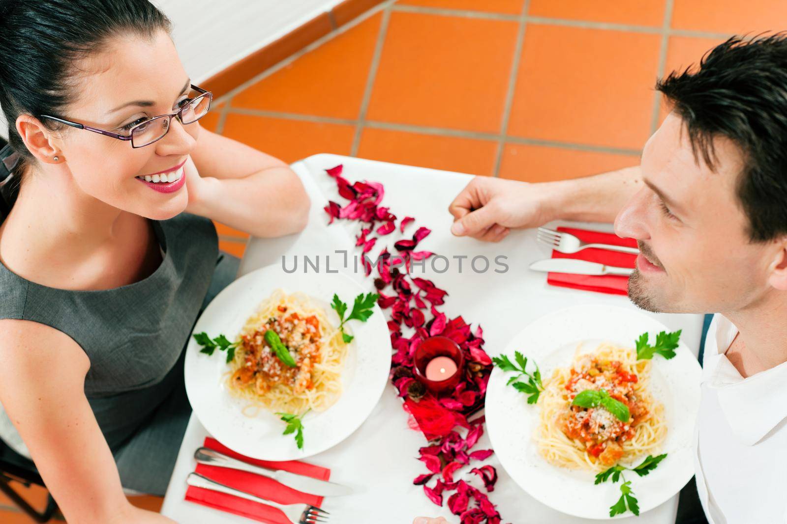 Couple at lunch or dinner; very romantic setting