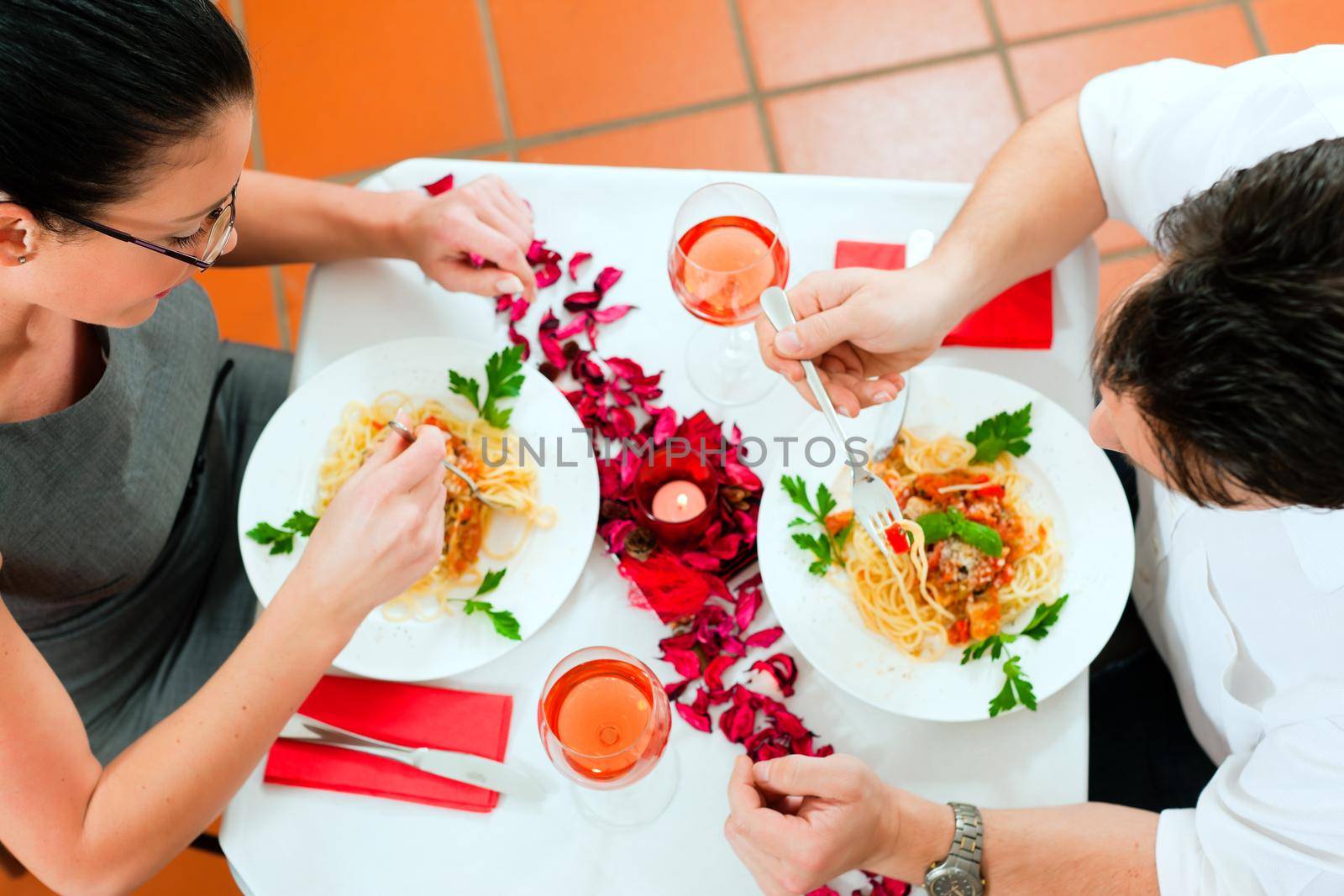 Couple at lunch or dinner; very romantic setting