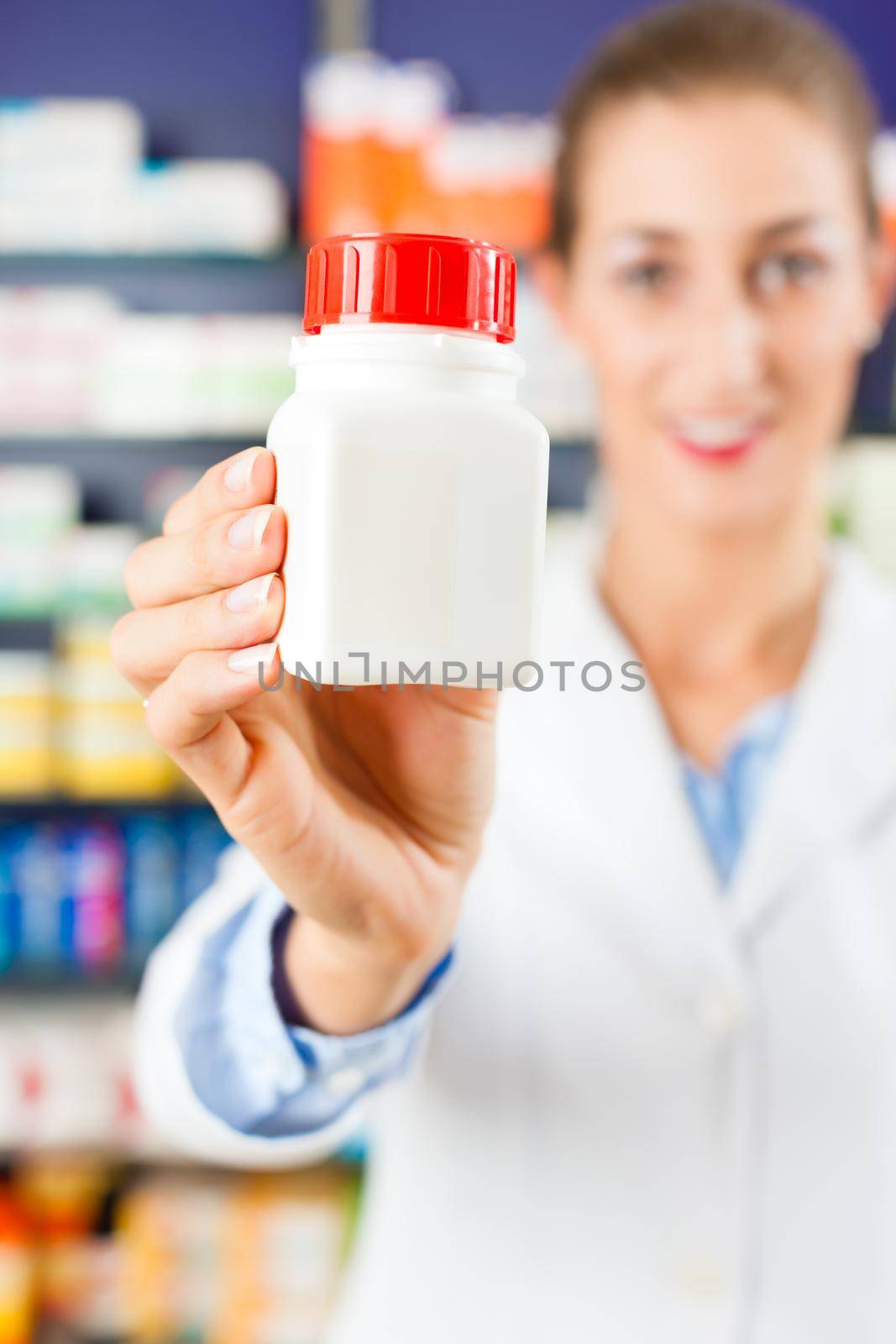 Female pharmacist in her pharmacy by Kzenon