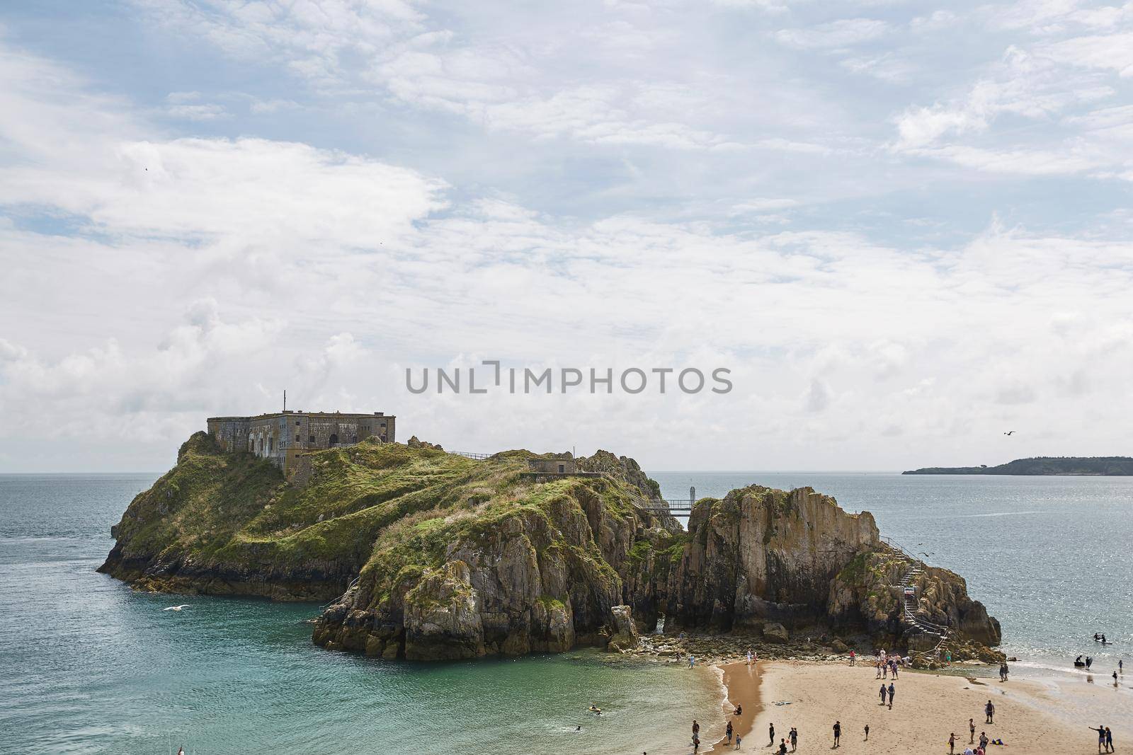 People at the beach in Tenby, an ancient walled town; now a tourist destination in the county of Pembrokeshire, south Wales, UK.