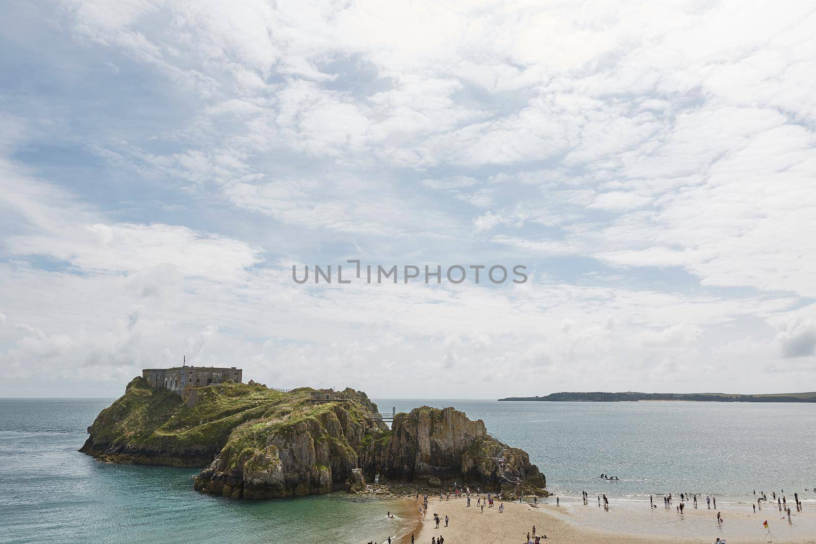 People at the beach in Tenby, an ancient walled town; now a tourist destination in the county of Pembrokeshire, south Wales, UK.