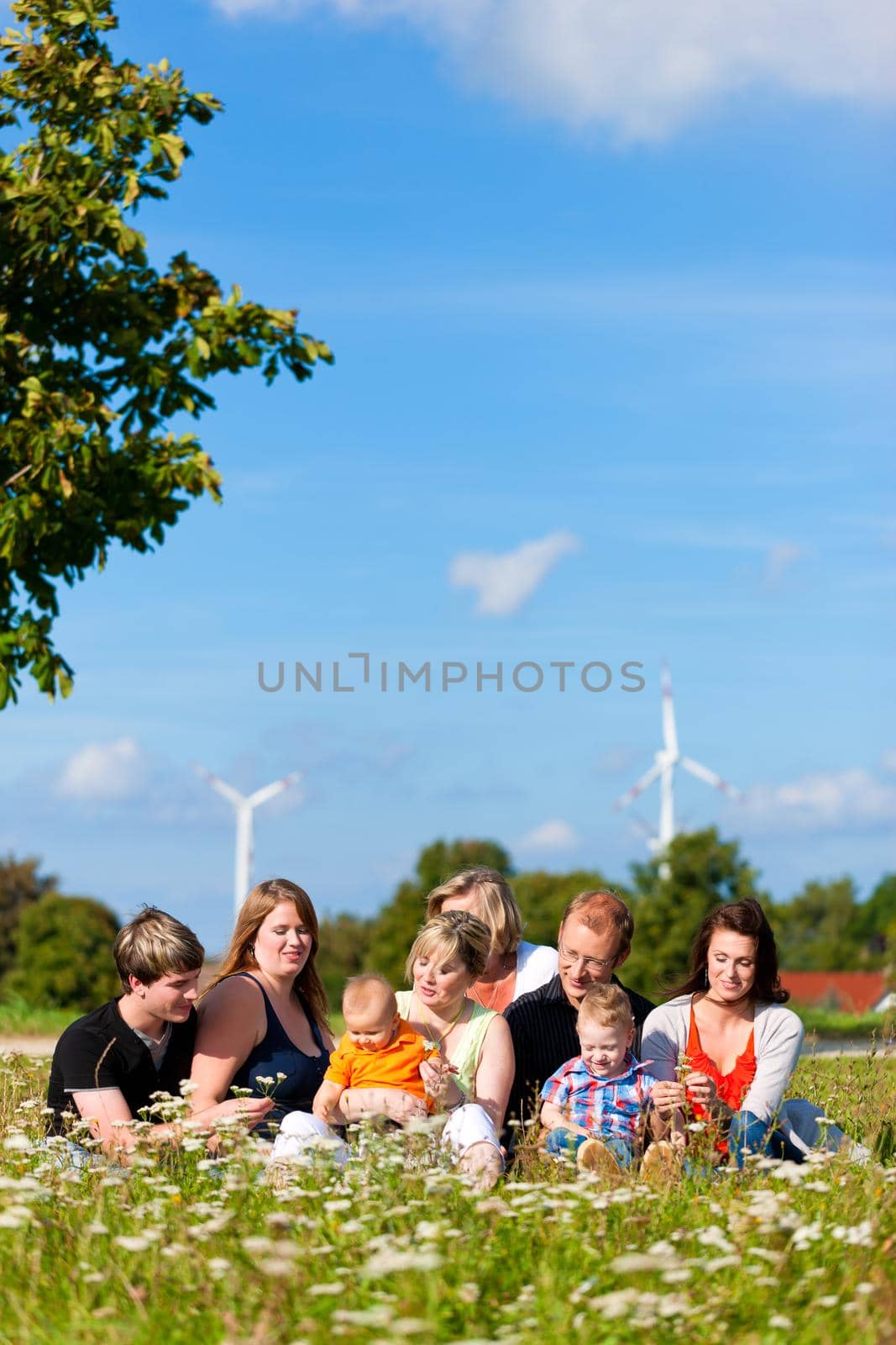 Family and multi-generation - fun on meadow in summer by Kzenon