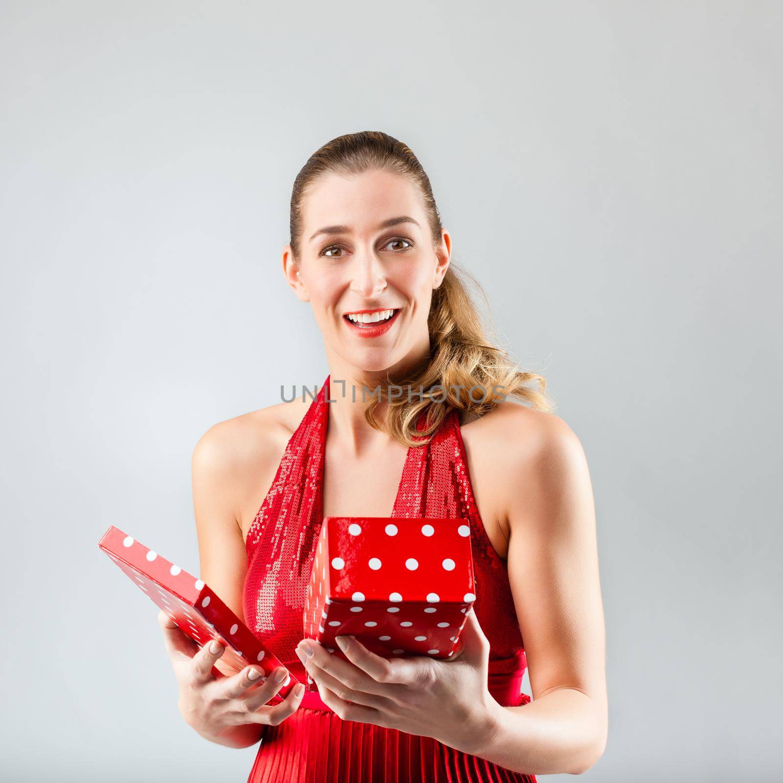 Woman opening the gift and is happy and smiling