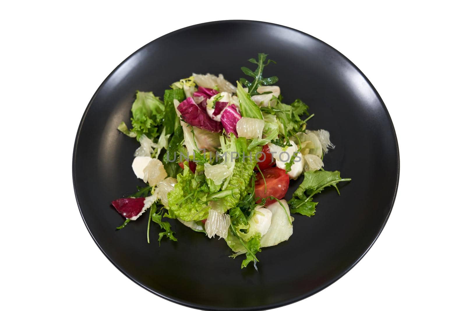Top view close up mix fresh lettuce leaves different colors in black modern plate on white background. Concept of juicy salad with fresh vegetables for maintain body weight.