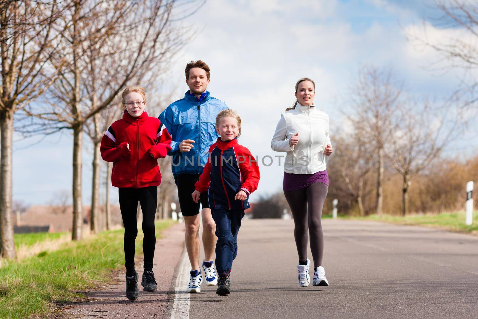 Family, mother, father and children are running or jogging for sport outdoors