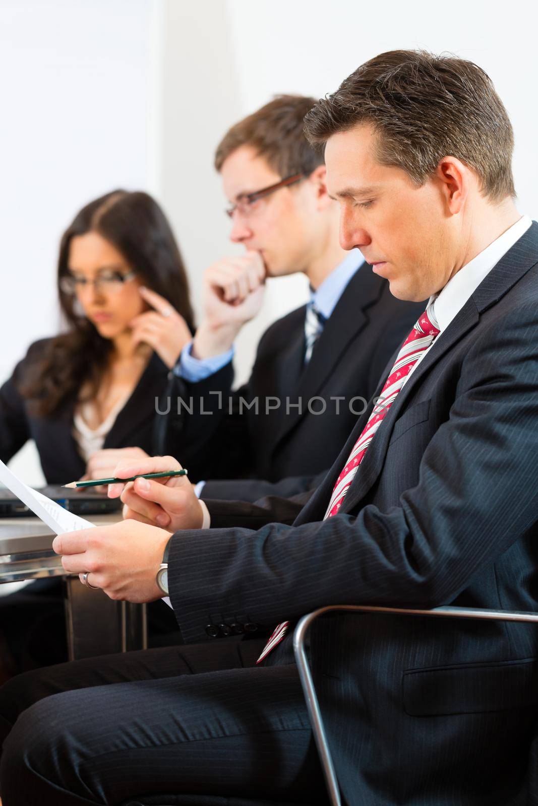 Business people sitting in a meeting or workshop in an office