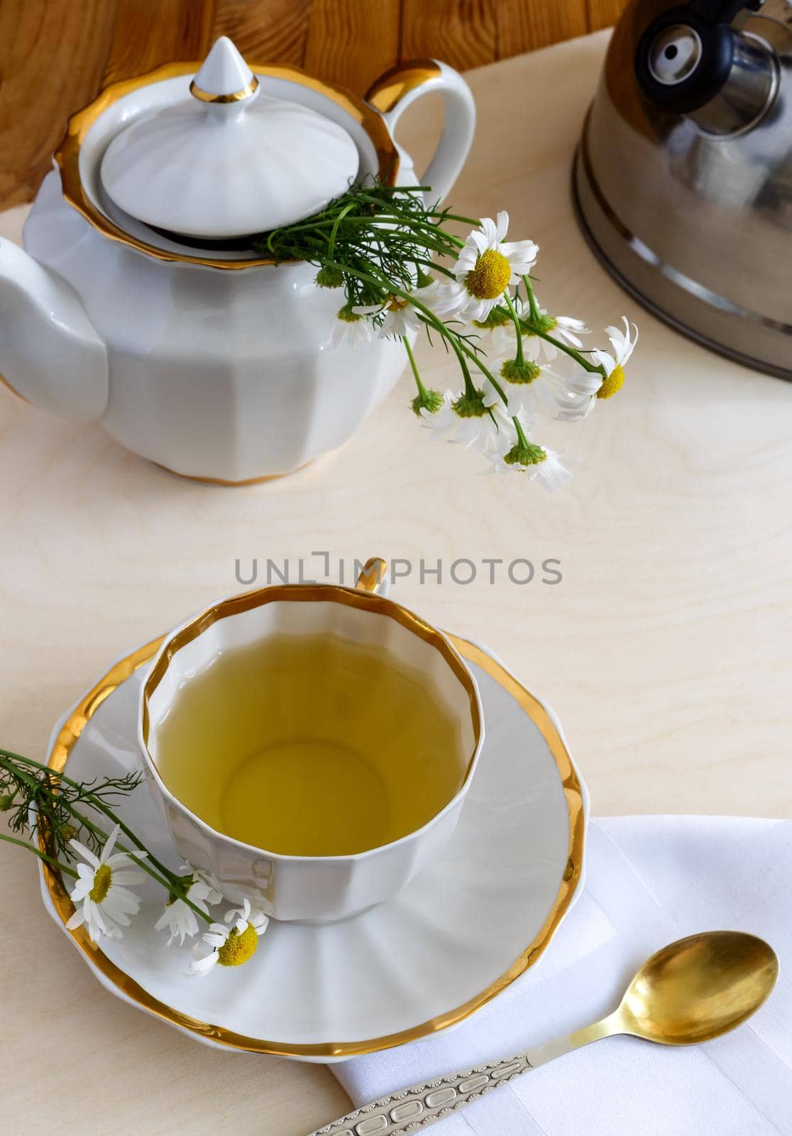 Medicinal chamomile is a valuable herbal medicinal raw material. Next in a Cup of herbal tea with chamomile infusion.
