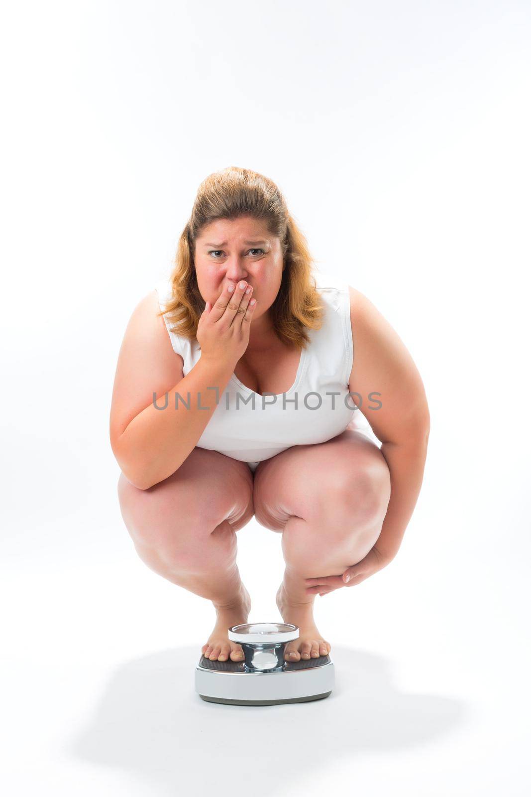 Obese young woman crouching on a scale by Kzenon